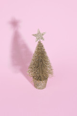 Christmas tree over light pink background.