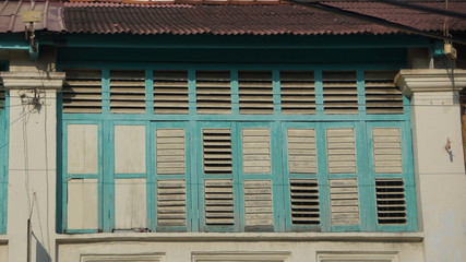 Beautiful blue windows of old shophouse in George Town, Penang