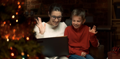 Fototapeta na wymiar Mother and son having a video call at Christmas