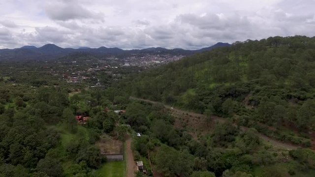 Aerial drone boom down shot of a mountain town from a rural setting