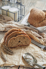 A beautiful loaf of sourdough bread from white wheat on a plate on a linen edge. Homemade pastries © oksanamedvedeva