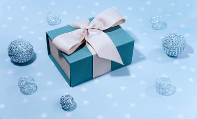 Blue gift boxe with Silver shiny Christmas bauble decoration.