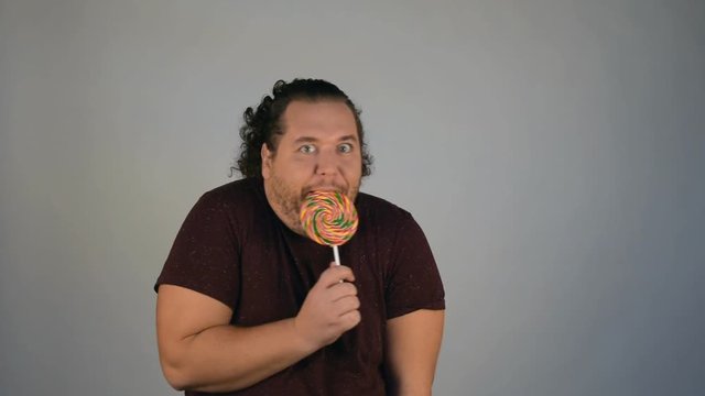 Funny fat man and a big candy. 