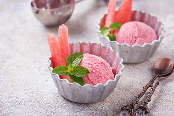 Watermelon ice cream in metal bowls