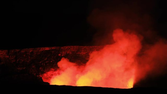 Night lava glow Kilauea Volcano crater dark Hawaii National Park. Most active volcano in USA. Big Island in Volcano National Park. Geological crater tourism destination for science and education.