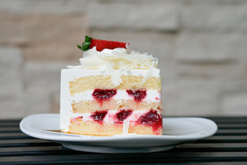Strawberry short cake on white plate.