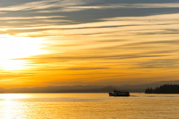 Fototapeta na wymiar boats at the sunset on the Lake Garda
