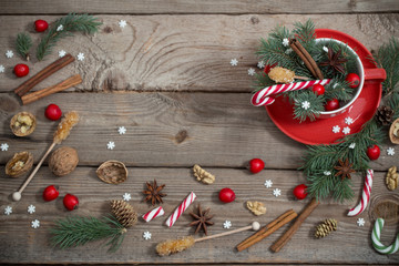 Christmas decorations in red cup on wooden background