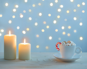 Fototapeta na wymiar hot chocolate with marshmallow on blue background