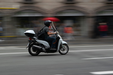 Fototapeta na wymiar Scooter Going Fast in Barcelona