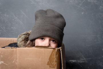 Sad girl in paper box