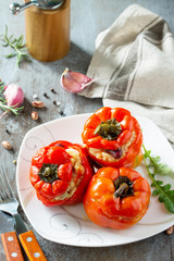 Stuffed Pepper with Rice, Tomatoes and Beans on a stone or concrete background. Vegetarian Healthy Food.