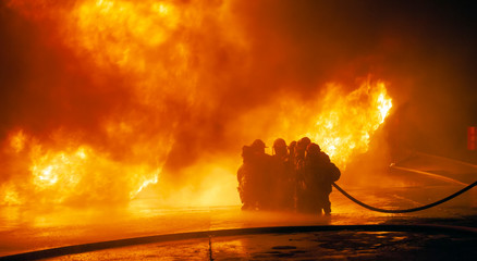 JOHANNESBURG, SOUTH AFRICA - OCTOBER, 2018 Firefighters spraying down fire during firefighting training exercise