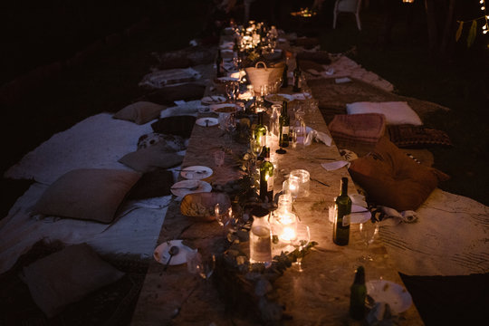 Dreamy Outdoor Floor Table Dinner Setting With Fairy Lights In A Garden