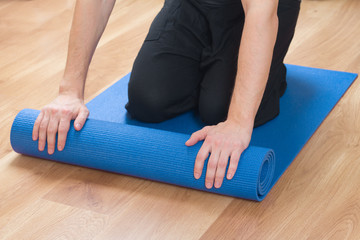 closeup of man hands with exercise yoga mat