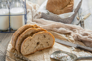 A beautiful loaf of sourdough bread from white wheat on a plate on a linen edge. Homemade pastries