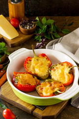 Stuffed peppers with turkey meat and cheese on a wooden table. Healthy food. Copy space.