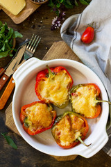 Stuffed peppers with turkey meat and cheese on a wooden table. Healthy food. Top view flat lay background. Copy space.