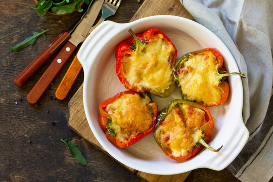Stuffed peppers with turkey meat and cheese on a wooden table. Healthy food. Top view flat lay background. Copy space.