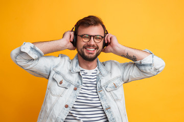 Cheerful modern man listening to music