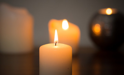 closeup of candle glowing in darkness