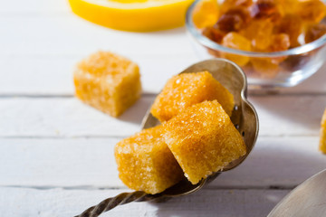 cup of tea, different leaves, honey, lemon ginger and brown sugar on white wooden table background