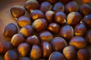 Chestnuts on a wooden bowl