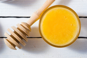 cup of tea, different leaves, honey, lemon ginger and brown sugar on white wooden table background