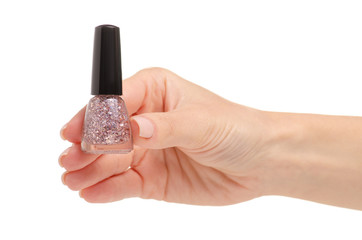 Nail polish pink glitter in hand on a white background. Isolation