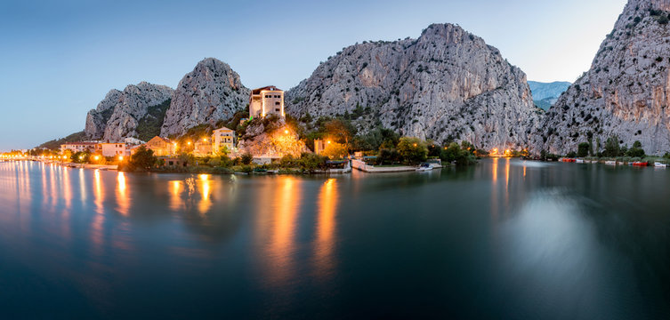 City of Omis, Dalmatia, Croatia. Blue hour landscape view in historical city centre of Omis and Cetina river. Popular holiday destination in Croatia