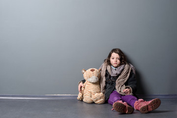 Tired girl hugging old toy