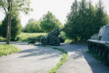Old metal green cannon from the time of Second World War. Weapon for fights from the past. WW2...