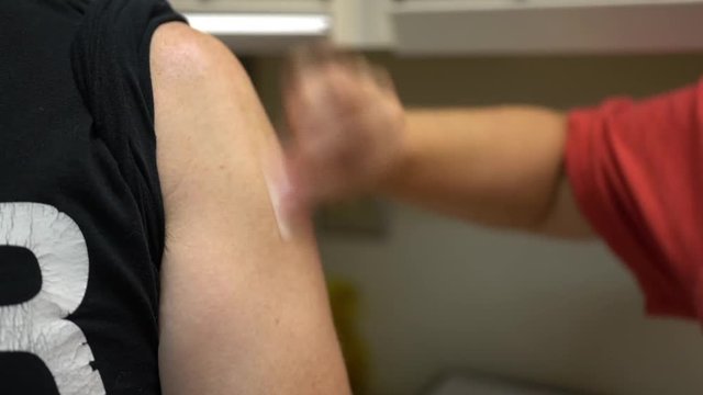 Male arm gets Flu Shot vaccine