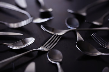 fork spoons knives background / beautiful serving tableware