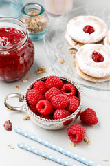 Bowl of raspberries and red jam.