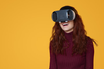 Excited woman using VR glasses