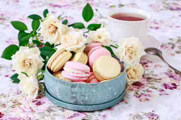 French macaroons and yellow roses.
