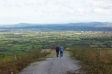 Young couple looking at the view of the city from the mountain