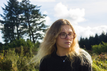 young girl in the mountains with glasses