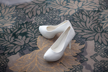 white shoes of the bride and bouquet