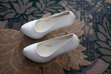 white shoes of the bride and bouquet