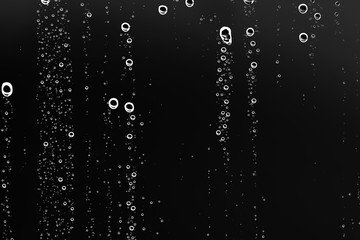 Fototapeta na wymiar black wet background / raindrops for overlaying on window, concept of autumn weather, background of drops of water rain on glass transparent
