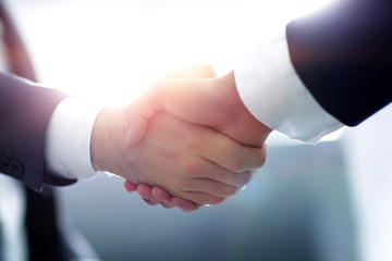 Close up of business handshake in the office - obrazy, fototapety, plakaty