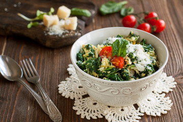 Bowl of scrambled eggs with spinach
