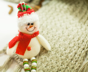 smiling snowman toy dressed in scarf and cap