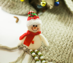 smiling snowman toy dressed in scarf and cap