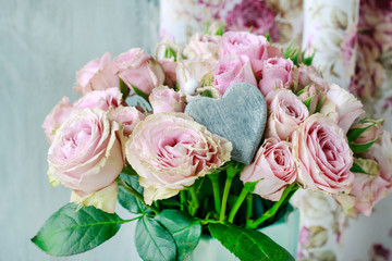 Bouquet of pink roses with wooden grey heart