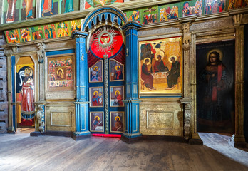 Fototapeta na wymiar Orthodox iconostasis inside the ancient wooden Trinity Church