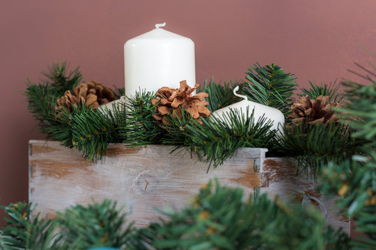 Candle box decorated with fir branches and pine cones