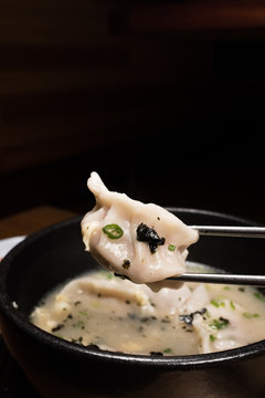 Asian dumpling on chopstick